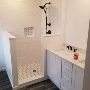 Modern white tiled bathroom with a walk-in shower and vanity