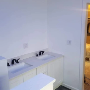 White double sink vanity with cabinets in a bright bathroom